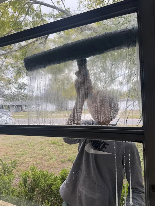 Youth entrepreneur cleaning windows