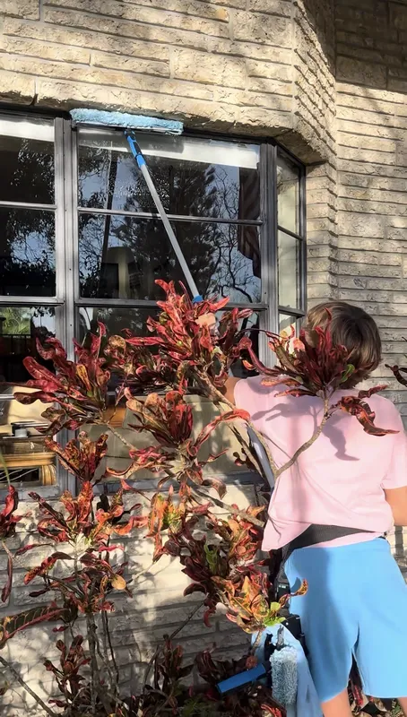 Youth entrepreneur cleaning exterior windows