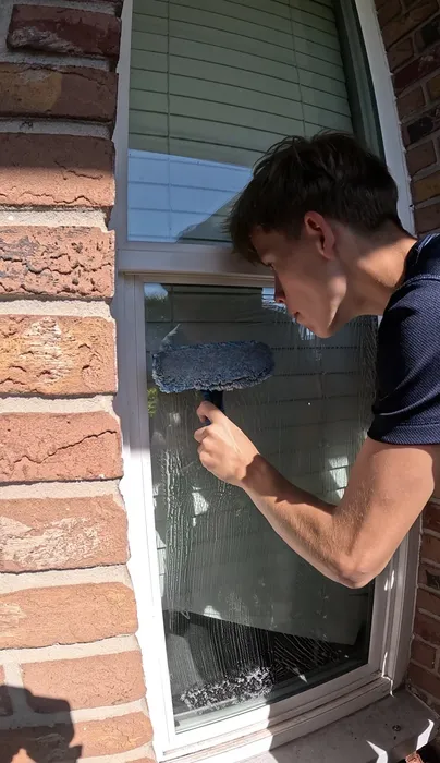 Youth entrepreneur cleaning windows
